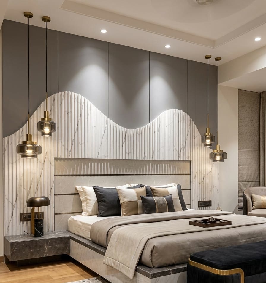 Wave-profile fluted marble headboard wall under layered accent lighting